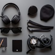 Modern man tech collection on wooden desk headphones, sunglasses, smartphone generated by artificial intelligence